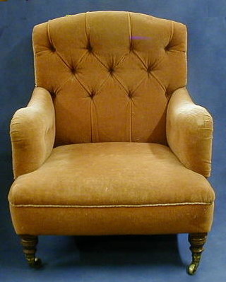 A Victorian mahogany framed armchair, upholstered buttoned material