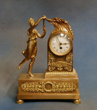A 19th Century French 8 day mantel clock with enamelled dial, Roman numerals contained in an arch shaped gilt ormolu case supported by a figure of "Education" on bun supports
