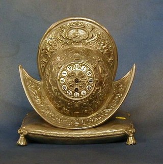 A Victorian 8 day mantel striking clock contained in a silvered Morion helmet case 