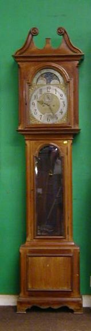An early 20th Century 8 day striking longcase clock, the 12" arched dial with phases of the moon, gilt metal spandrel, minute indicator and silvered chapter ring with Arabic numerals by H L Brown & Sons London & Sheffield contained in a mahogany case