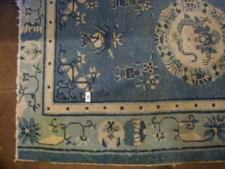 A 1930's Hong Kong blue ground and floral patterned Chinese rug 76" x 51"