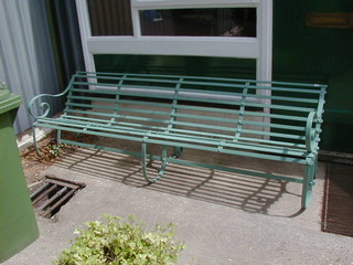 A 19th Century turquoise painted iron bench 94"