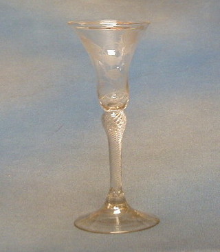 An  18th Century trumpet shaped ale glass, the bowl cut butterfly amidst flowering branches, raised on an air twist stem 8"