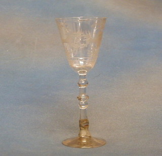 An 18th Century trumpet shaped wine glass with armorial decoration and  motto Plutot Mourir Que Manquer Deeoy, raised on a double bowled stem and circular foot, the base with old lead repair 