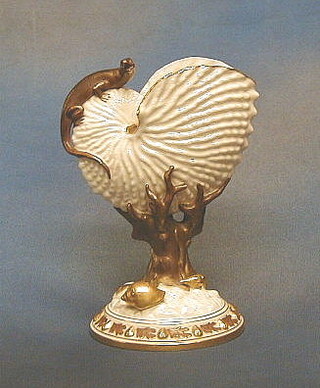 A Victorian Worcester porcelain vase in the form of a scalloped shell surmounted by a lizard and raised on a naturalistic base, the base impressed UH 9"