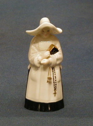 A Royal Worcester porcelain candle snuffer in the form of a standing nun 4", the interior with black Royal Worcester mark