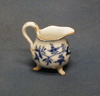 A 19th Century miniature Meissen porcelain jug with blue and gilt decoration, raised on 3 feet 2"  (1 foot f)