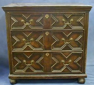 An oak Jacobean chest of 3 long drawers with brass swan neck drop handles raised on bun supports 38"