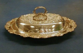 An oval silver plated entree dish and cover