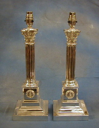 A pair of large silver plated Corinthian column electric table lamps