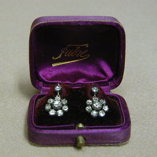 A pair of gilt earrings set white stones