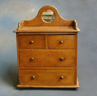 A Victorian honey oak miniature dresser, the raised back with three-quarter gallery above 2 short and 2 long drawers with tore handles 14"