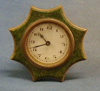 An Art Deco bedroom timepiece contained in a green Bakelite shagreen effect case