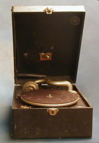 A HMV manual gramophone contained in a black fibre carrying case and a collection of various 78rpm records