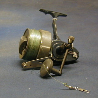 A Mitchel 498 multiplying fishing reel complete with instructions