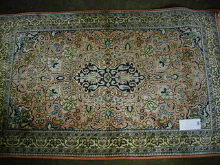 A fine quality Persian silk pink and floral ground carpet with central medallion within multi-row borders 48" x 31"