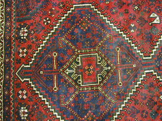 A contemporary red ground Persian carpet having octagons to the centre within multi-row borders 125" x 90"