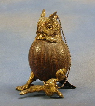 A fine quality 19th Century gilt ormolu and coconut table lighter, in the form of an owl sat on a branch with glass eyes, 9"