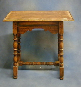 An 18th Century style rectangular oak occasional table raised on turned and block supports with crossbanded top, 27"