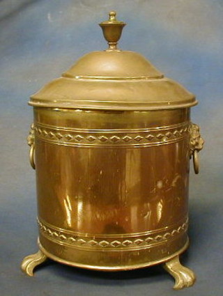 A circular brass coal bin