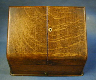 A Victorian oak stationery cabinet with fitted interior, the base fitted a drawer 15"
