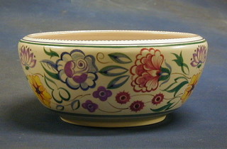 A circular Poole pottery bowl with floral decoration, the base impressed 434, 9"