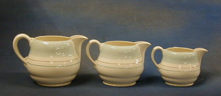 A set of 3 Royal Staffordshire Clarice Cliff ceramic graduated pottery jugs with blue and silver banding