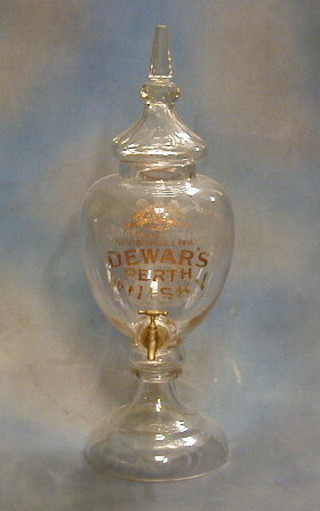 A Victorian glass Dewars bulk whiskey container, marked Royal Warrant to her Majesty The Queen, over 50 old medals awarded Dewars Perth Whiskey Ltd, Established 1846 (sight chip to the top rim)  30" high  