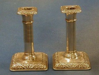 A pair of 19th Century embossed "silver" candlesticks 5" (f)