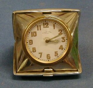 A silver cased travelling clock with enamelled dial and Arabic numerals contained in a silver case by Penlington & Batty of Liverpool, contained in a plain silver case, London 1919