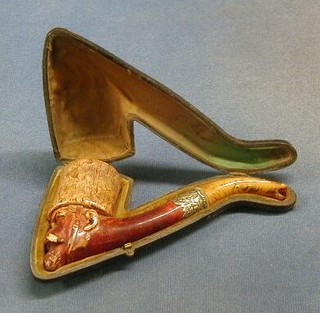 A 19th Century carved Meerschaum pipe in the form of a Russian soldiers head, with silver mounts and amber mouth piece cased