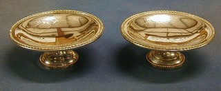 2 circular engraved silver comports, on circular bases 6"