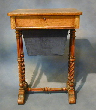 A Victorian bleached mahogany work table fitted a drawer above a deep basket raised on spiral turned supports united by a turned and fluted H framed stretcher by Chidley & Sons, Late Miles & Edwards of Oxford St. London 20"