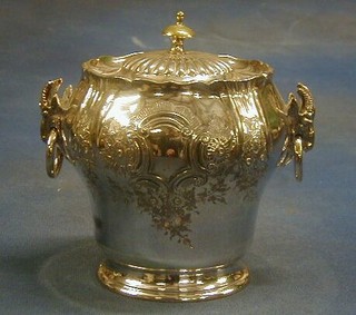 A circular silver plated biscuit barrel with hinged lid and rams mask ring drop handles