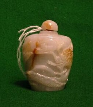 A 19th/20th Century Oriental carved "jade"  snuff bottle carved dragons