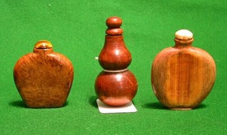 A 19th Century double gourd shaped wooden snuff bottle and stopper 3", a 19th Century oval wooden snuff bottle and stopper 2 1/2" and a  19th Century Oriental wooden snuff bottle and stopper 3"
