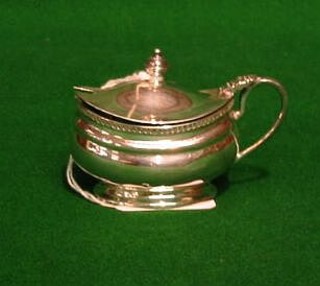 An oval silver mustard pot with hinged lid and blue glass liner, Birmingham 1949