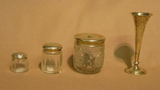 A circular cut glass dressing table jar with silver lid, Birmingham 1915, 2 small cut glass dressing table jars with silver lids and a silver trumpet shaped specimen vase (4)