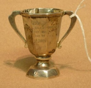 A miniature silver twin handled trophy cup