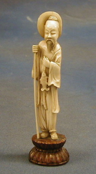 A 19th Century carved Japanese ivory figure of fisherman 6", on a hardwood base