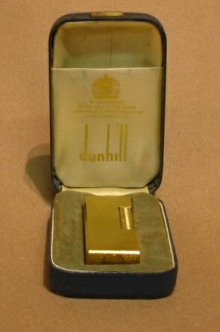 A gold plated Dunhill lighter, marked US.RE24163