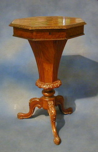 A Victorian inlaid walnutwood octagonal work table of conical form, the top inlaid a chessboard and raised on tripod supports 18"