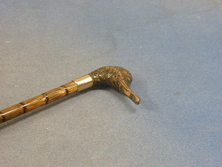 A 19th/20th Century lady's parasol, the carved handle in the form of a ducks head set glass eyes (1 missing)