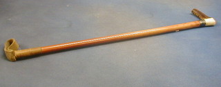 A riding crop with silver band and stag horn handle