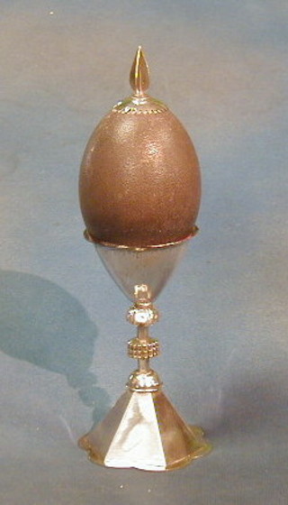 An ostrich egg raised on an Eastern silver plated stand