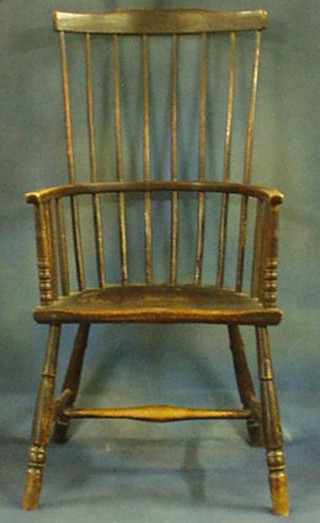 An 17th/18th Century elm stick and rail back carver chair with solid seat, raised on turned supports with H framed stretcher