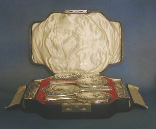 An Edwardian 5 piece embossed silver backed dressing table set decorated birds, Birmingham 1907 comprising two hair brushes, 2 clothes brushes and a hand mirror