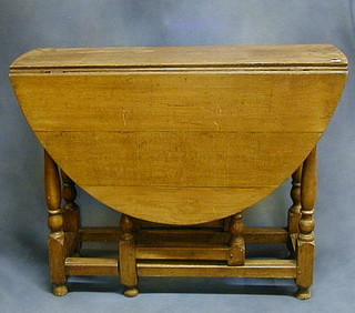 An early 18th Century oak oval drop flap gateleg dining table fitted a drawer, raised on turned and block supports 39"