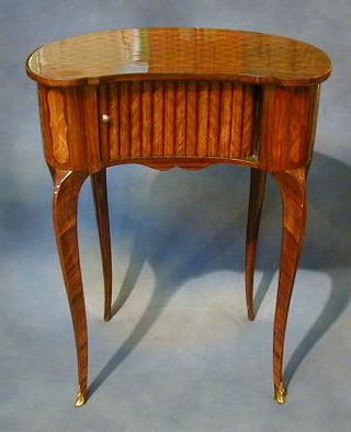 A pair of French style kidney shaped bedside cabinets with inlaid tops, the interior fitted drawers enclosed by a tambour shutter, raised on cabriole supports 23"