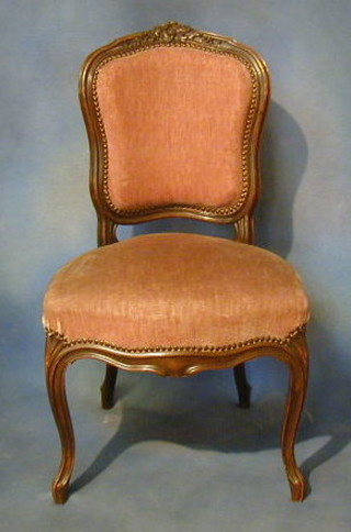 A pair of French 19th Century carved walnutwood show frame salon chairs with upholstered seats and backs on cabriole supports